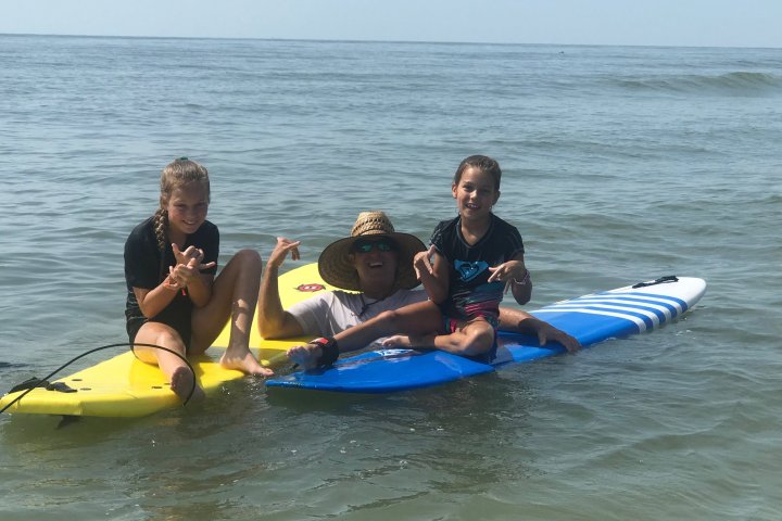 a group of people riding on the back of a boat in the water