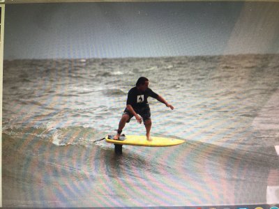 a young man riding a wave on a surfboard in the water