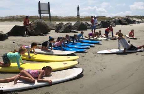 a group of people sitting at a beach