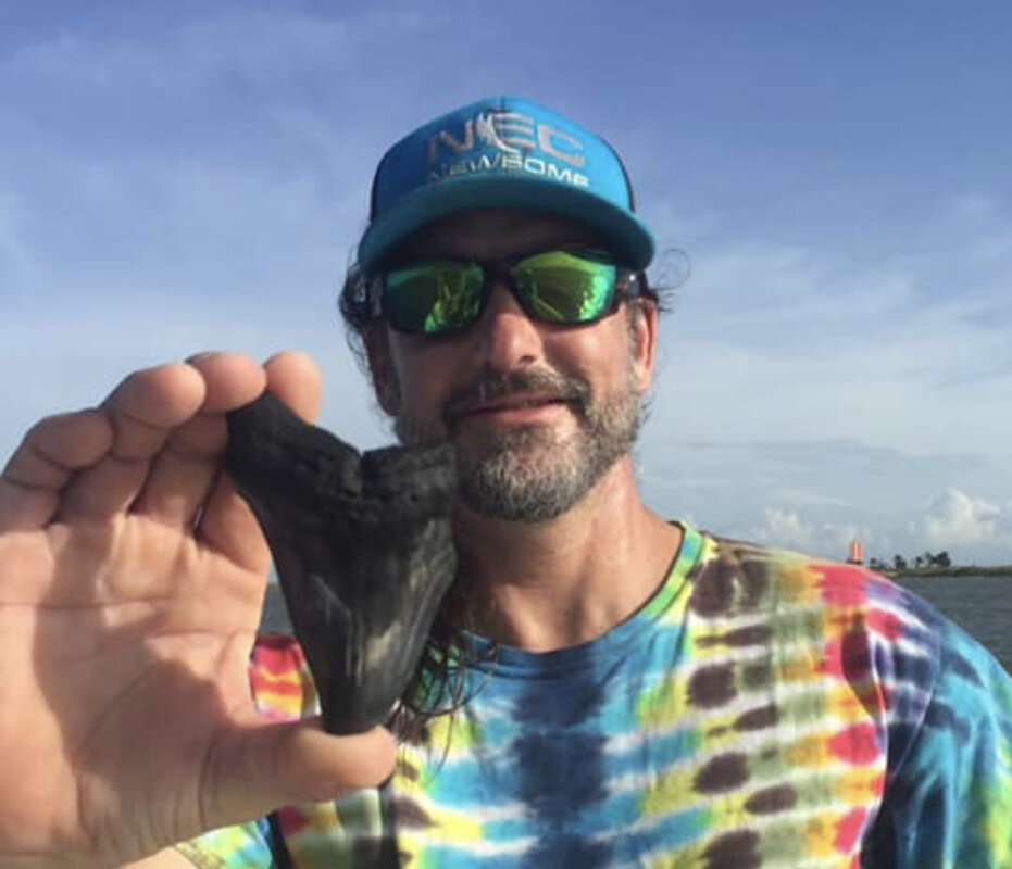 a man holding a fish