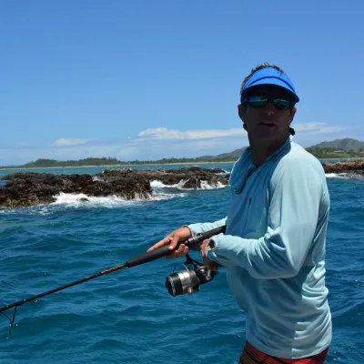 a man standing next to a body of water