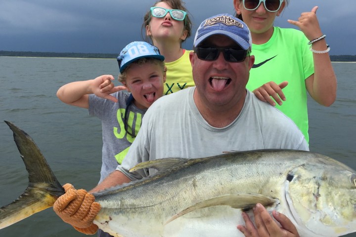 a man holding a fish in the water