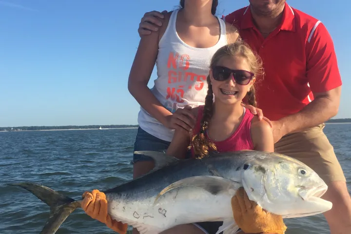 a person holding a fish in the water