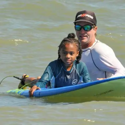 a person riding on the back of a boat in a body of water