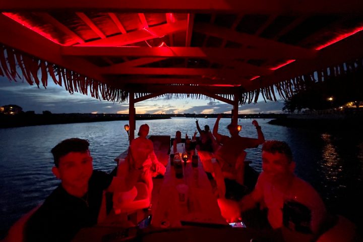 a group of people standing in front of a body of water